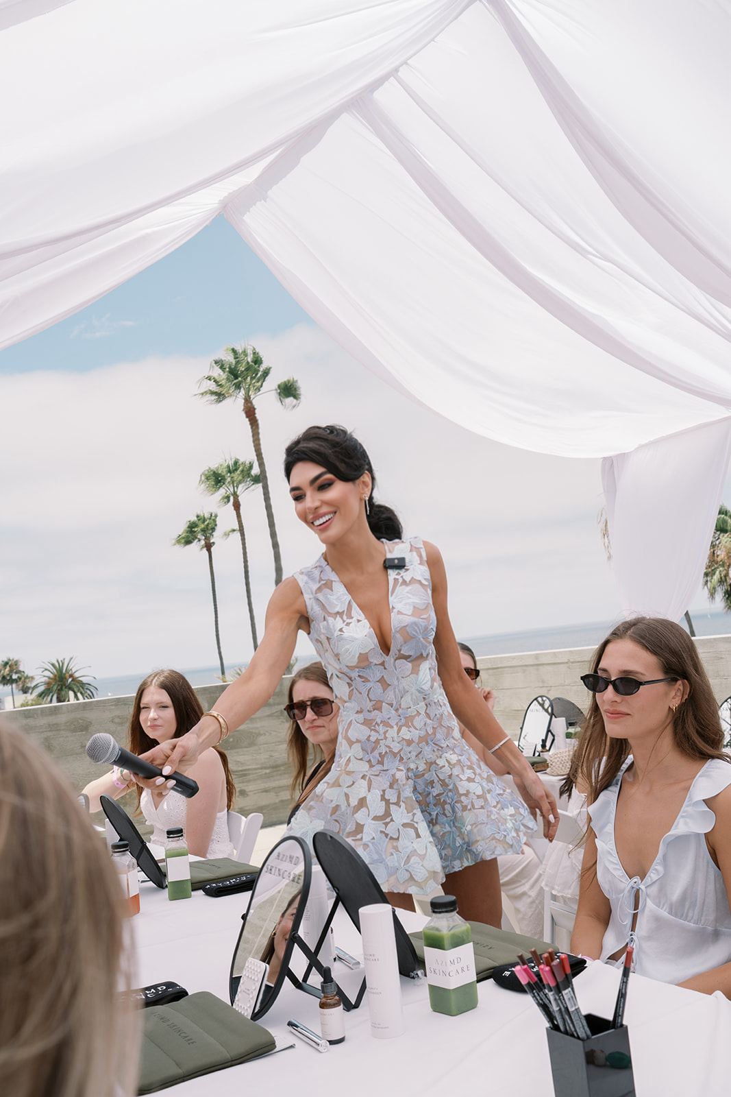 Dr. Azadeh Shirazi presenting AziMD Skincare at a community event in La Jolla